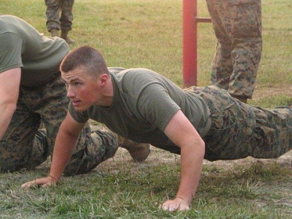 Muscular soldier in uniform doing push-ups